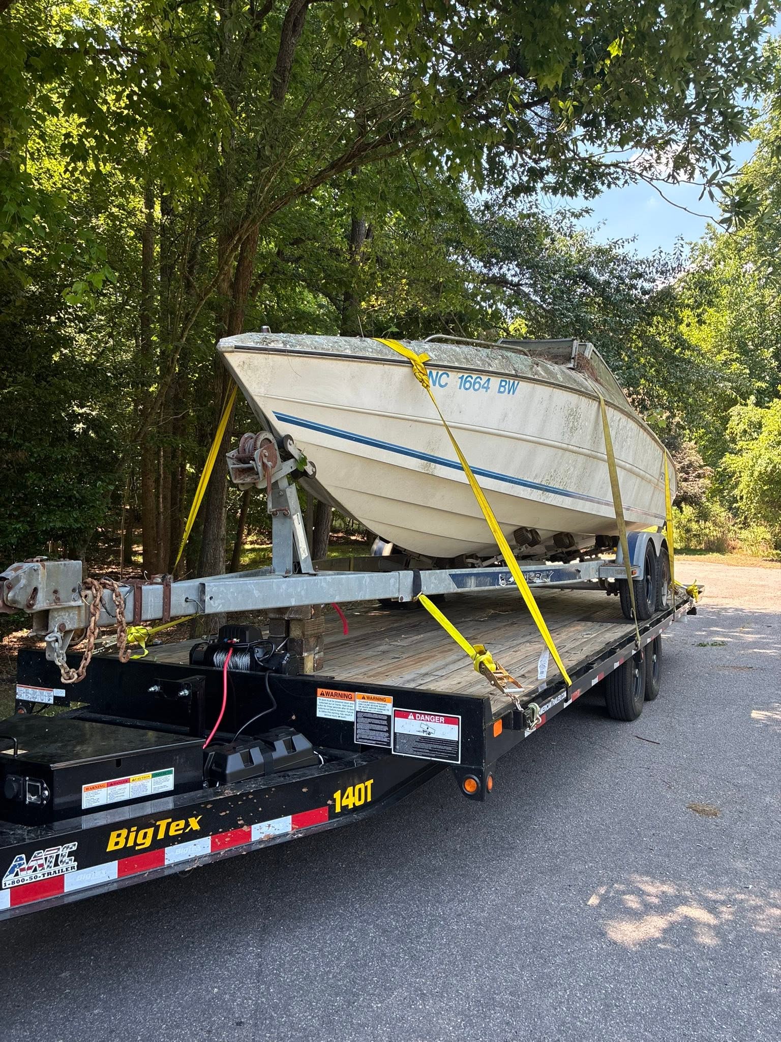 Boat secured on a trailer, ready to be hauled away